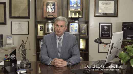 Criminal Defense Attorney David E. Grande sitting at desk